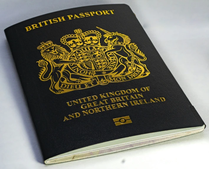 a british passport is opened on top of a table