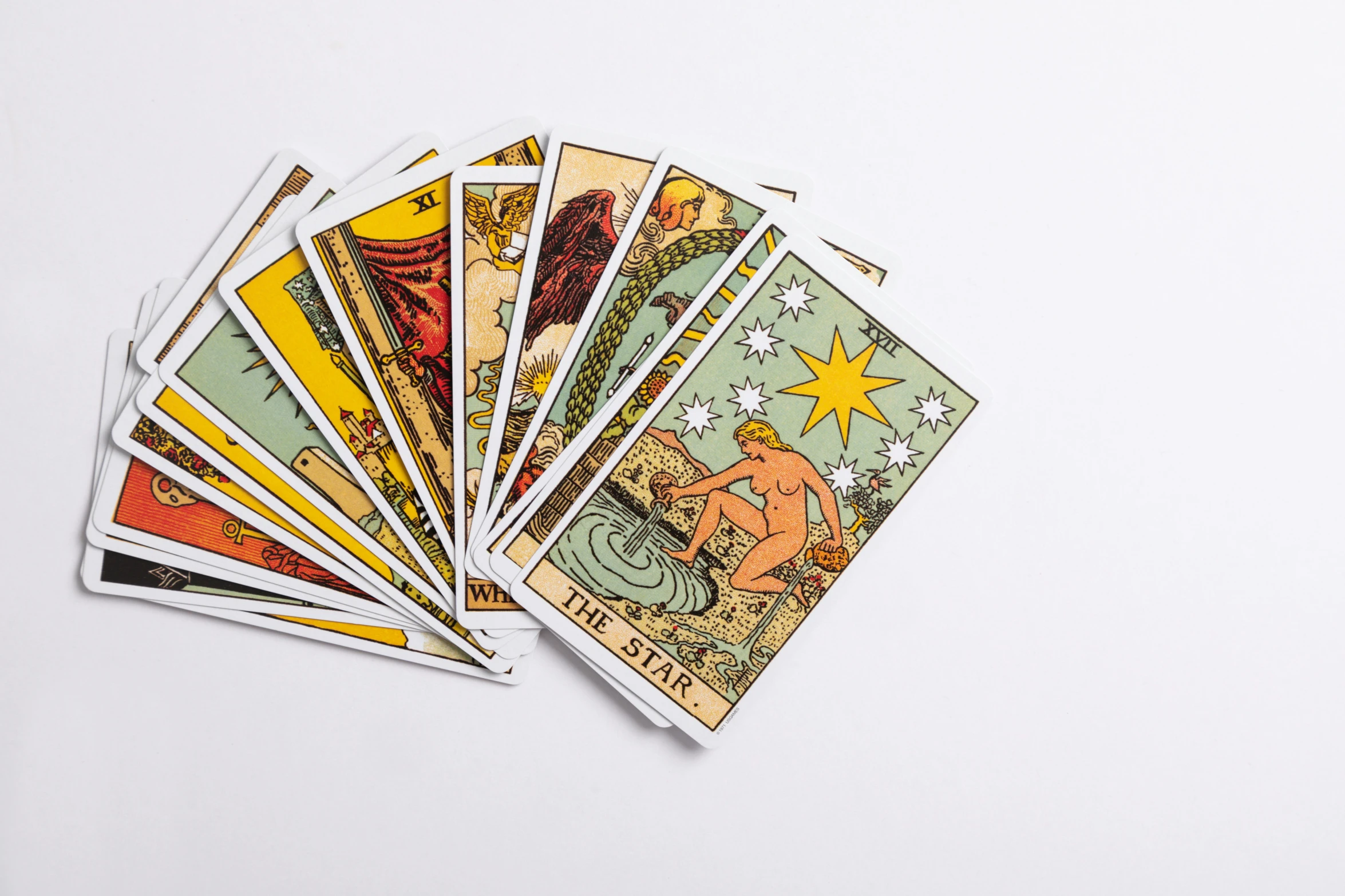 a set of twelve tarot cards placed on a white surface