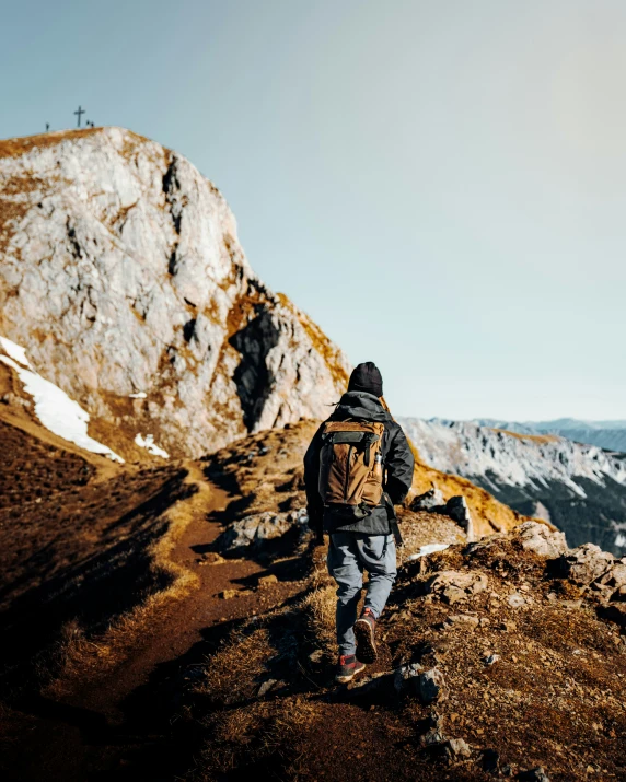 a man on top of a mountain looking at the mountains