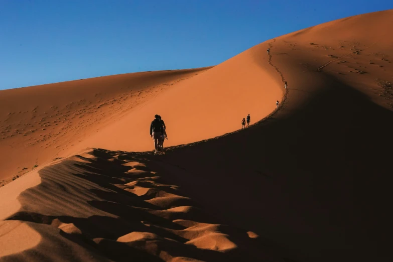 a person riding down a trail through the desert