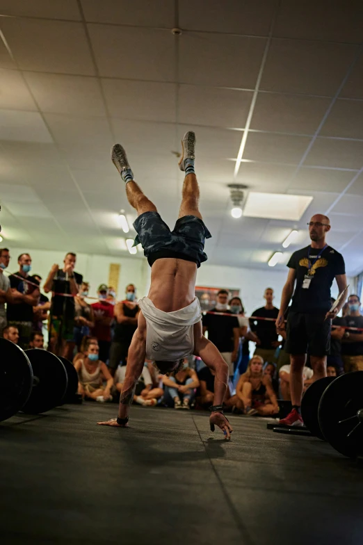 a man doing a hand stand on top of a table