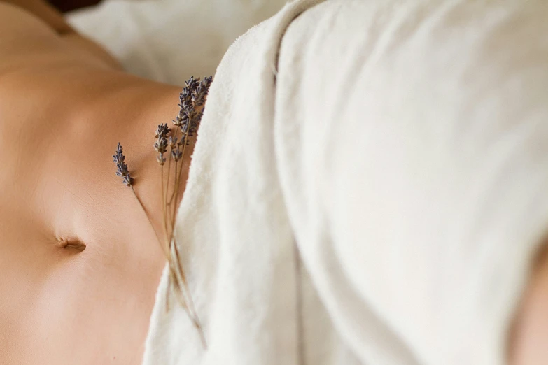 a  woman lying in bed next to pillows