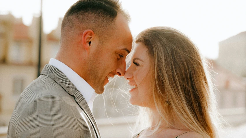 man and woman are posing for the camera