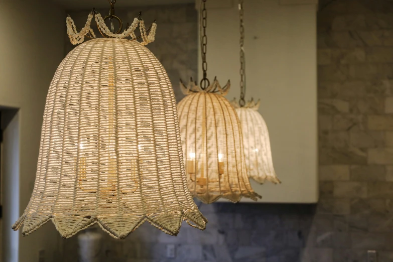 two lamps hanging from a ceiling above a sink