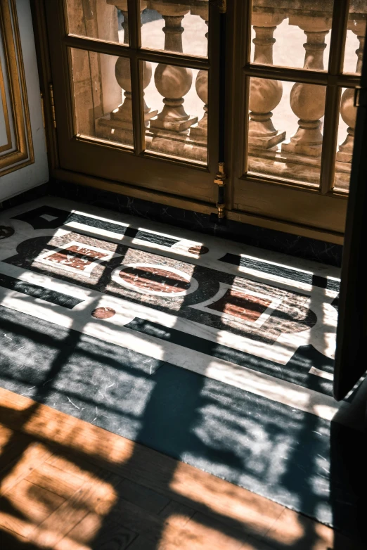 sunlight streams in from the window onto a floor with a tile design