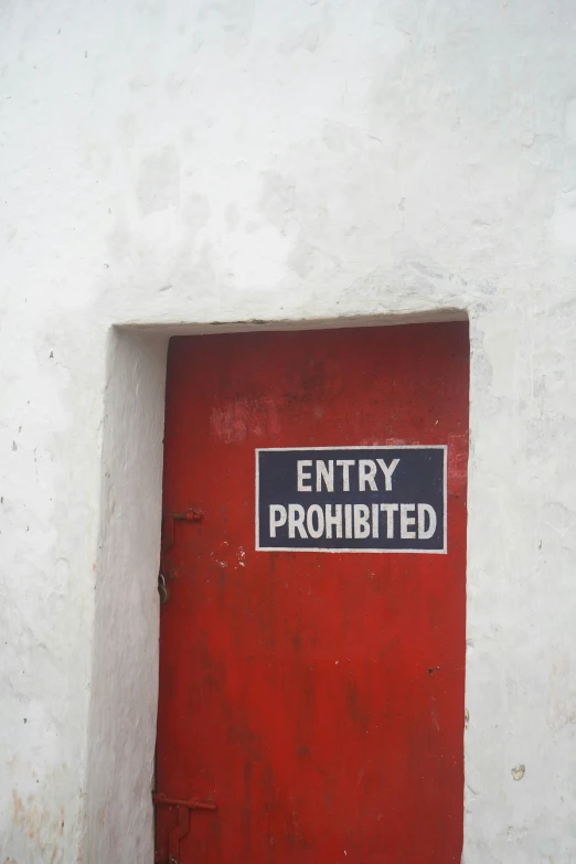 the sign is mounted to the outside wall of a building