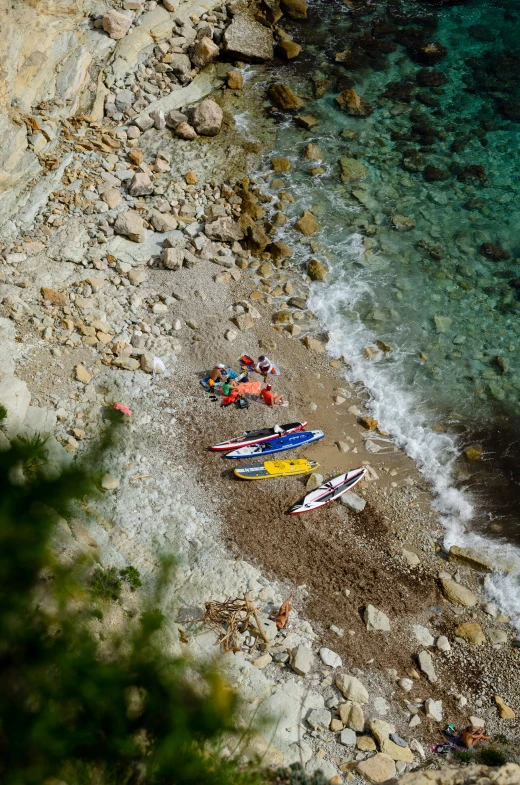 the beach has canoes and is on top of a hill