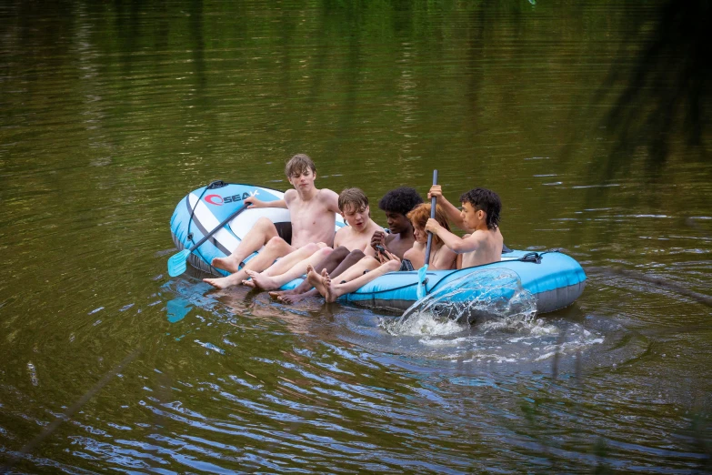 there are many people sitting on an inflatable raft