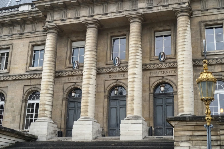 three tall buildings with columns on the front and sides