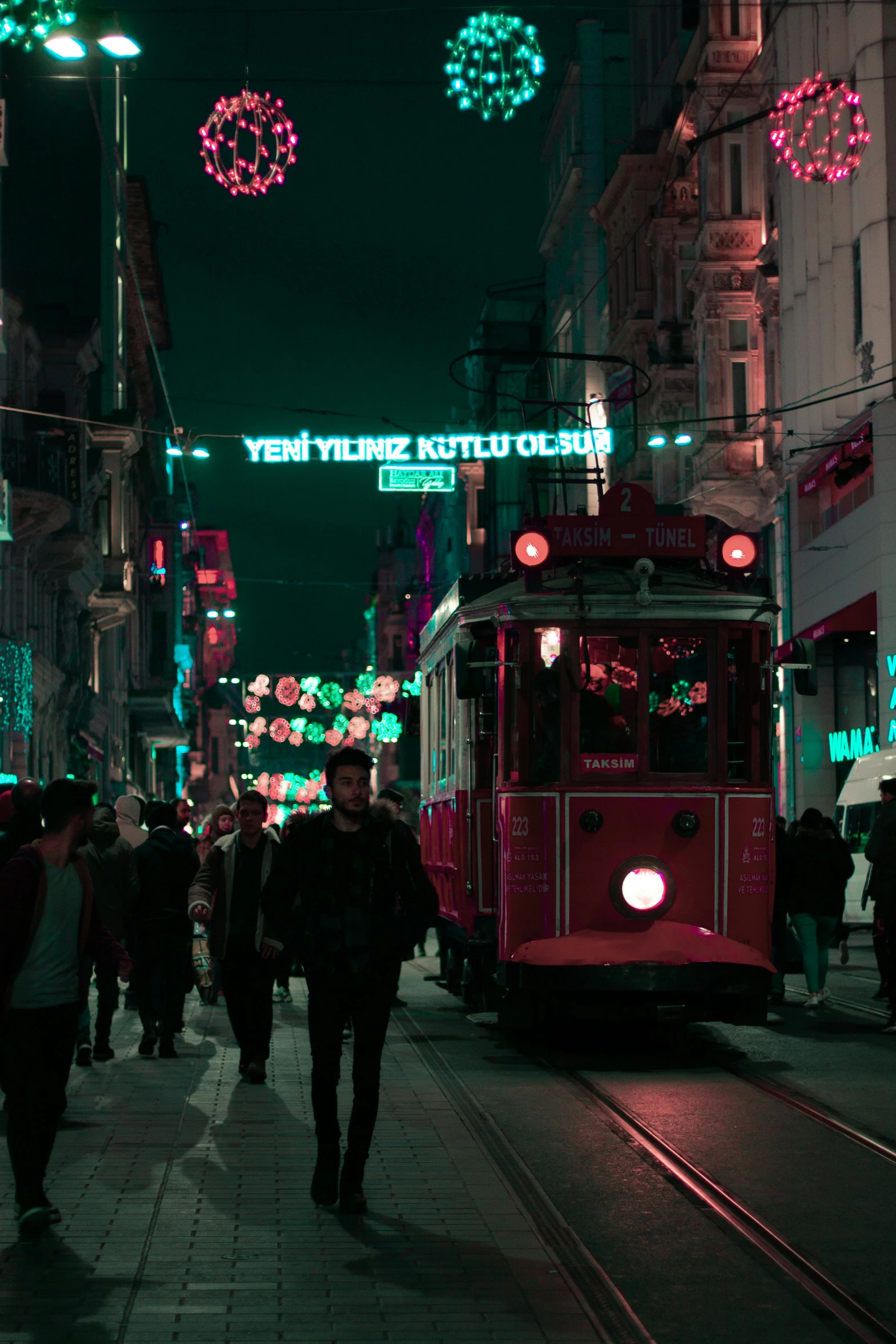 a tram passing down a city street at night