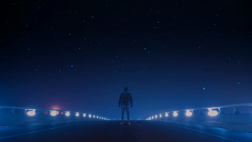 a person standing on a road at night