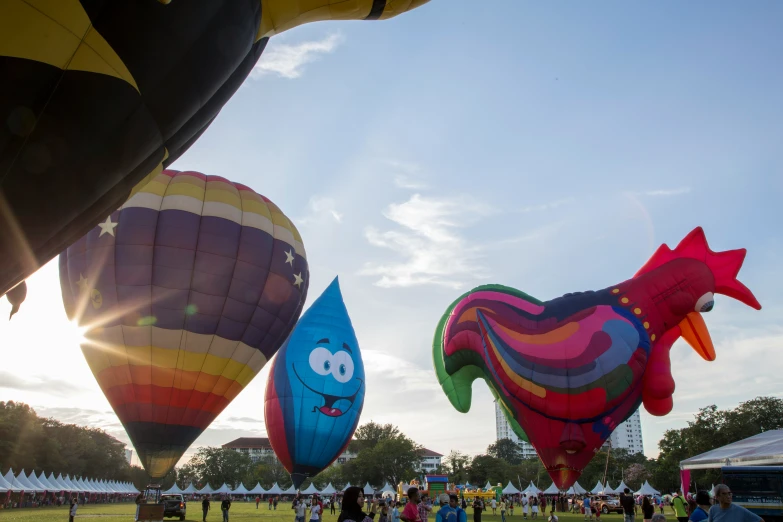 people flying  air balloons with faces in various colors