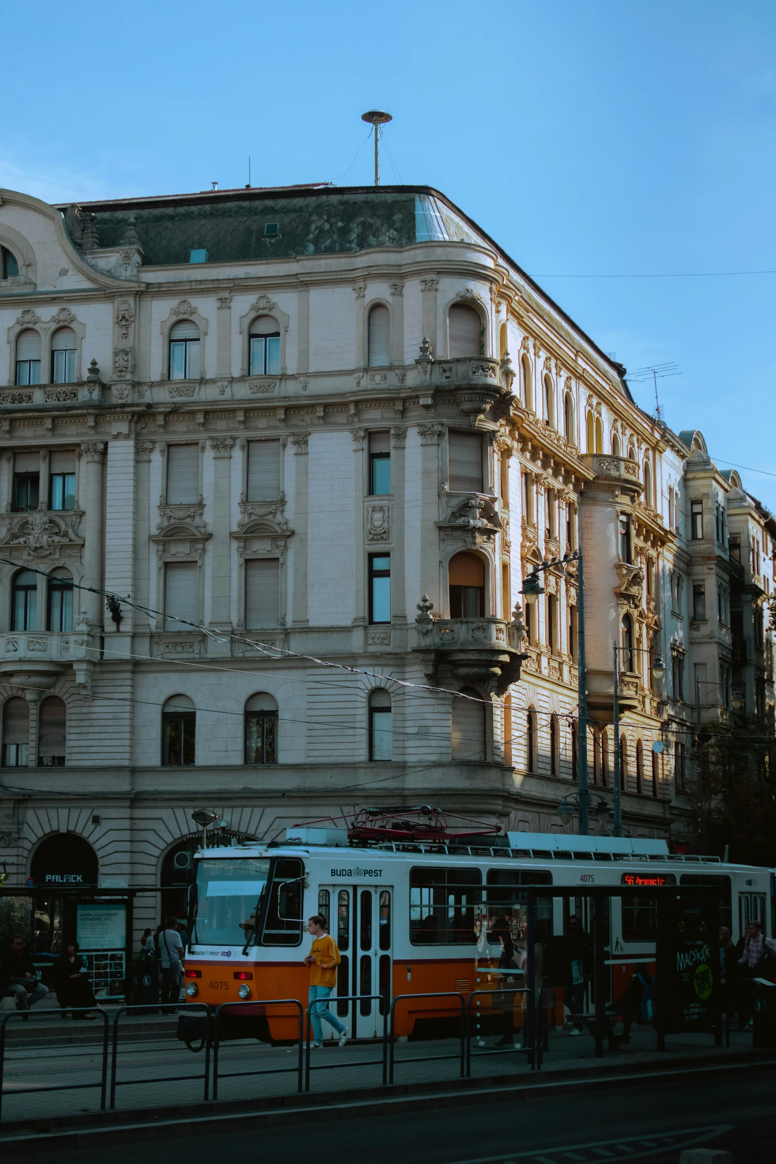 a street scene with a bus in front of an old building