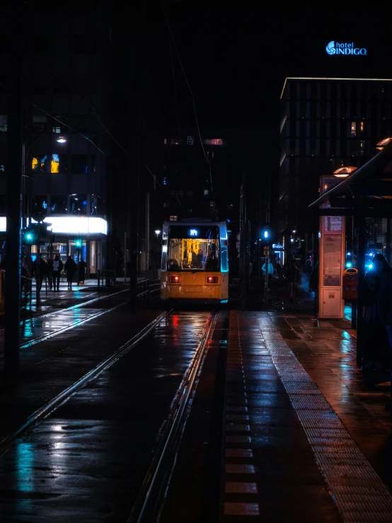 a public transit bus on a city street at night