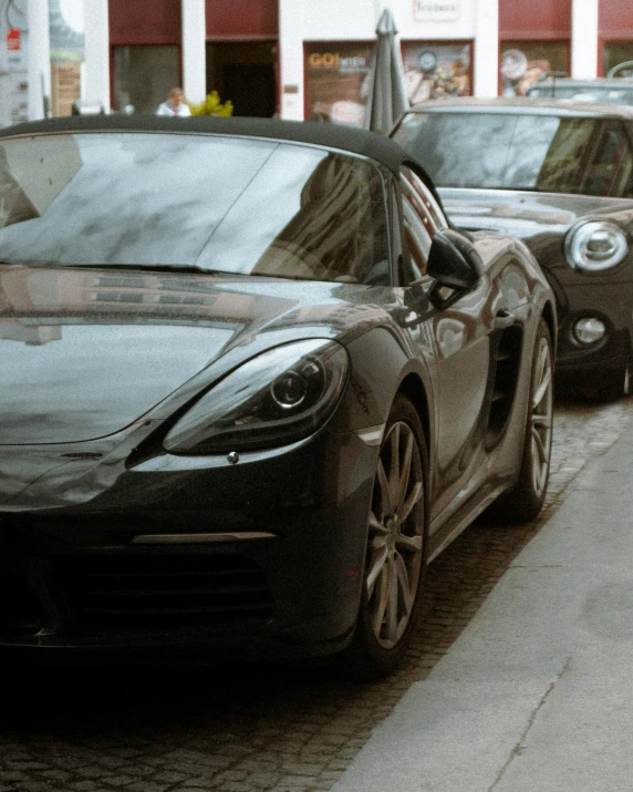 a couple of cars that are parked by a curb