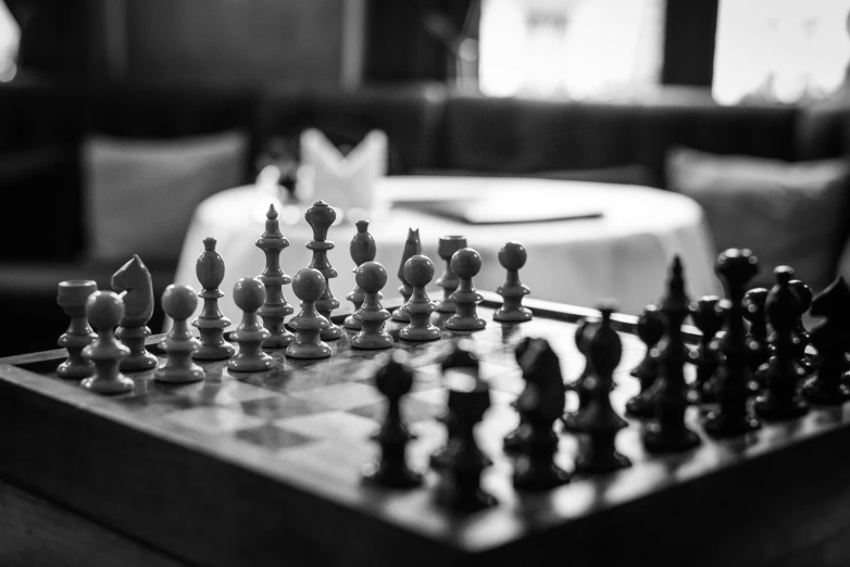 a chess board on a coffee table next to a couch