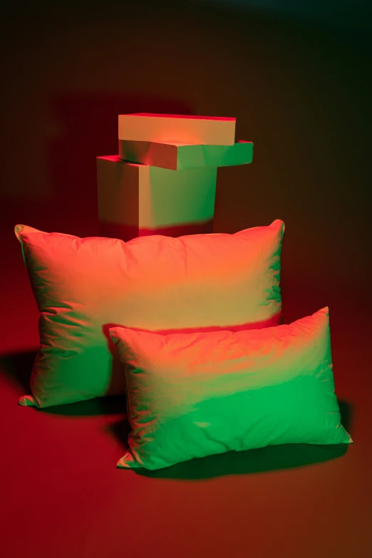pillows are placed on the floor against a red background