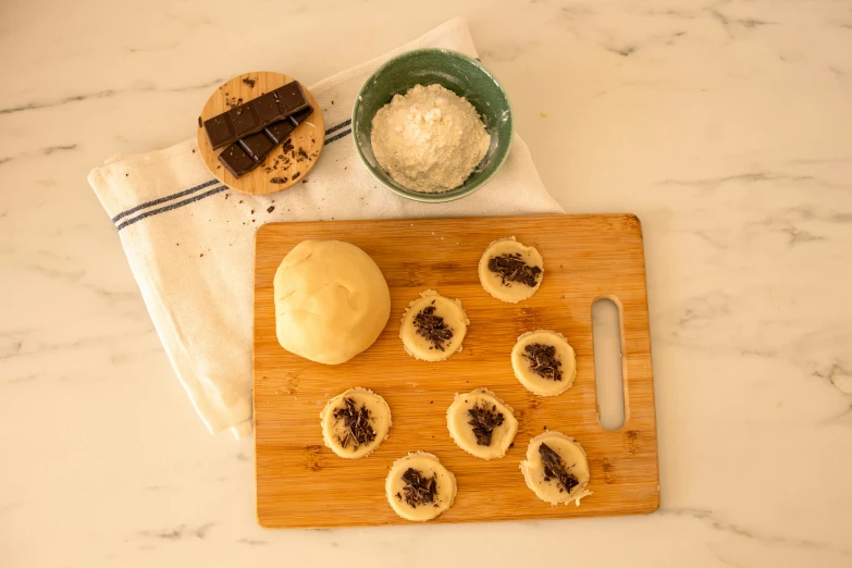 the  board is holding some small desserts