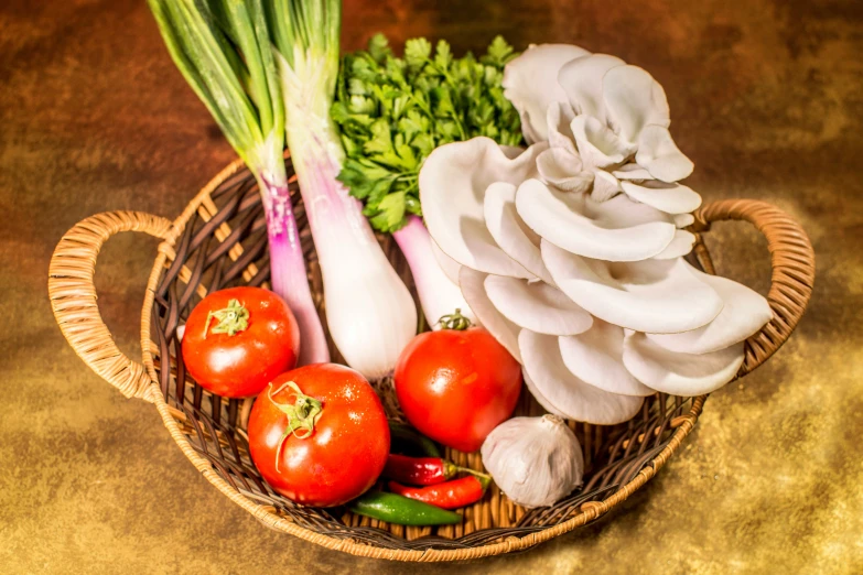 tomatoes and other vegetables in a basket with some onions