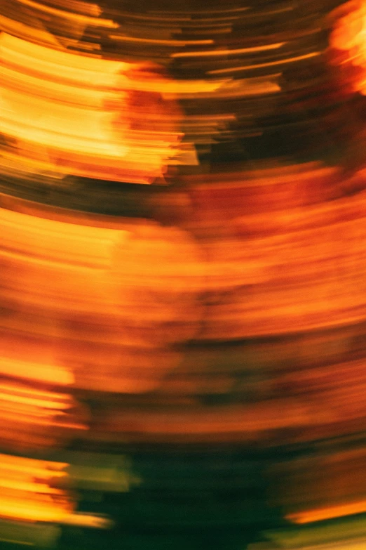 an abstract blurry picture of a green, yellow and red object