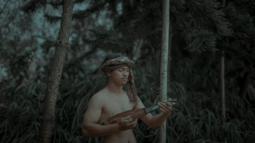 an african man holding a snake and a walking stick