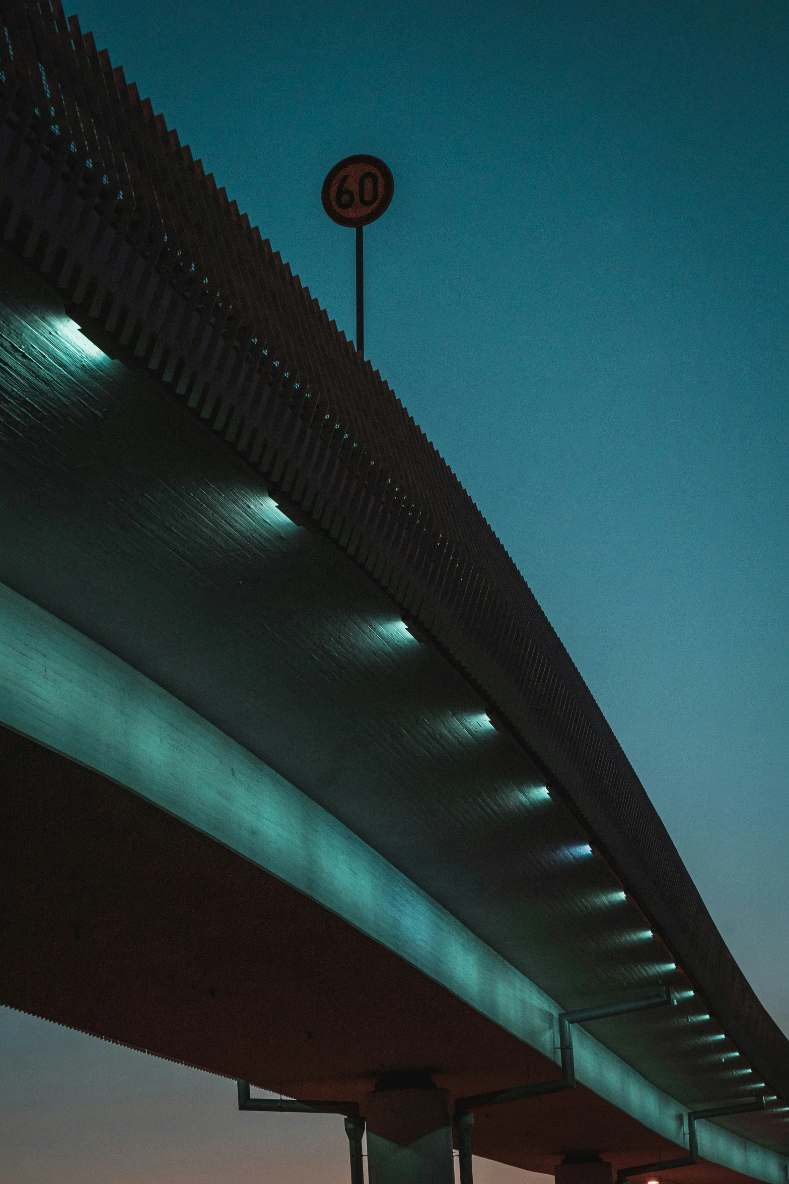 the light at night shows a green glow underneath the bridge