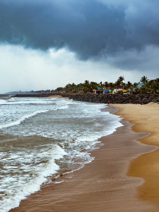 a storm over the beach with some houses on it