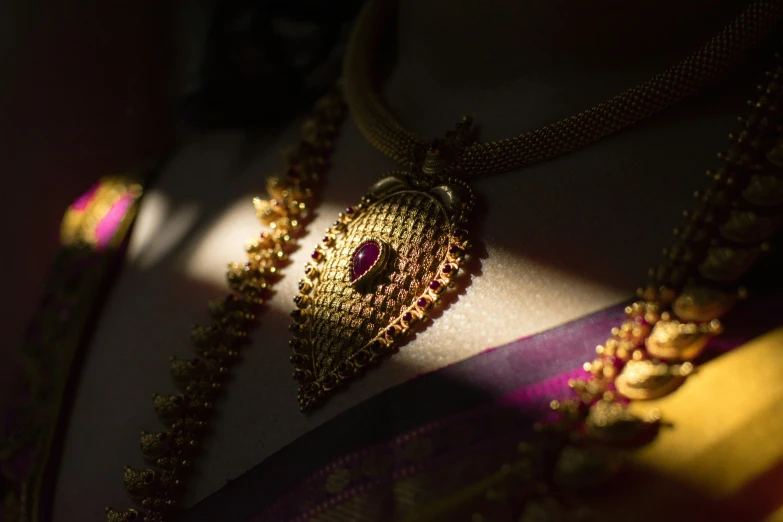 close up view of a golden necklace and some beads