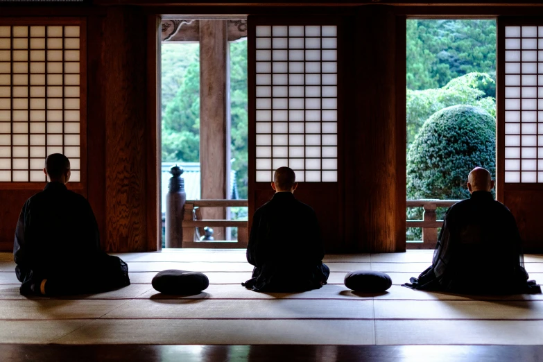 men sitting down in the middle of a room