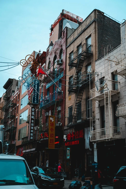 buildings with multiple balconies and signs line the street