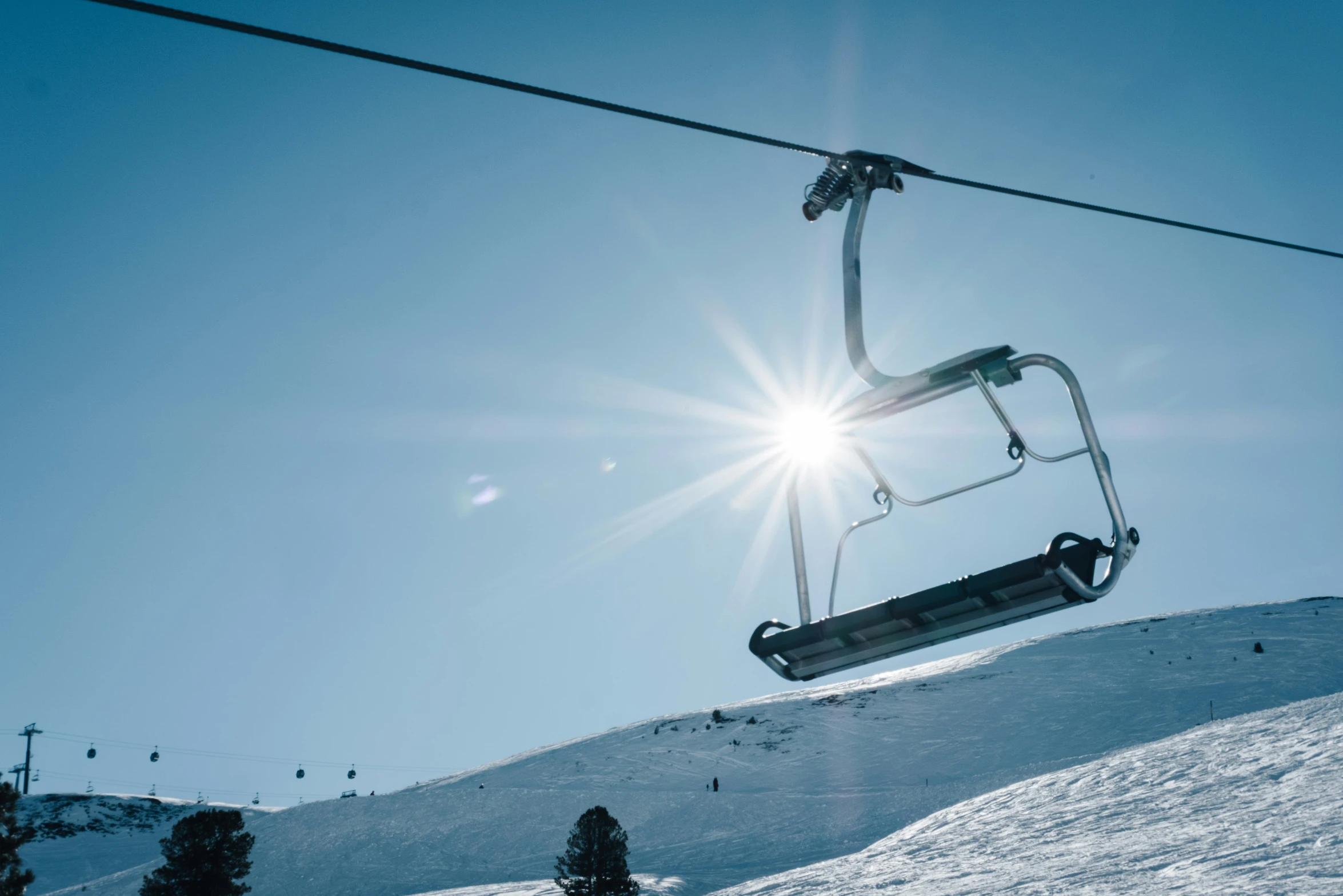 the skier is jumping off the ski lift