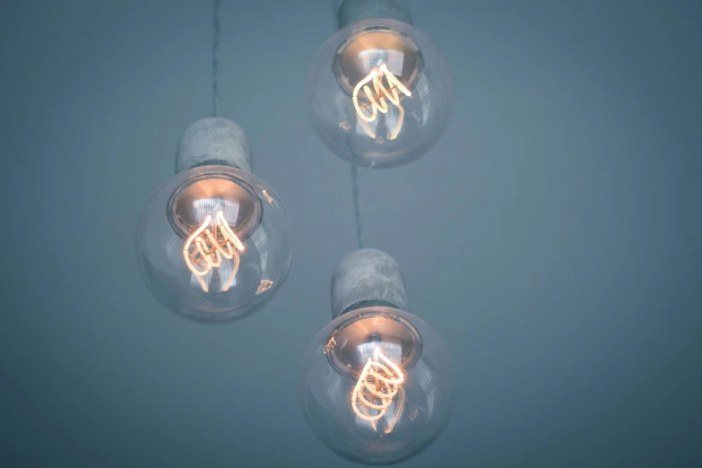 light bulb lights sitting on a table and reflecting off the wall