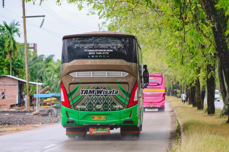 the rear end of a bus driving down a road