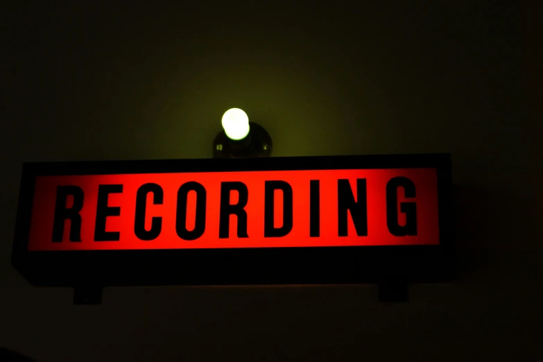 an old fashioned sign lit up with green and red light