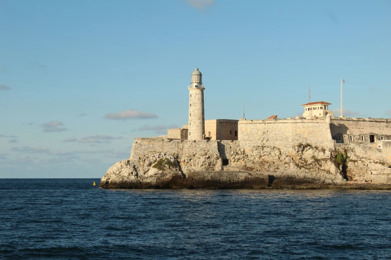 a lighthouse on an island near the water