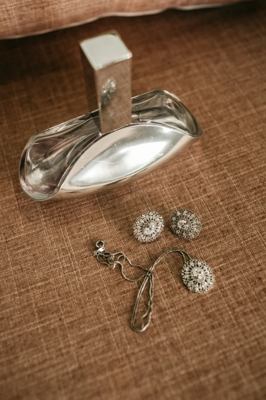 a pair of dandelion earring hooks are laying next to a door