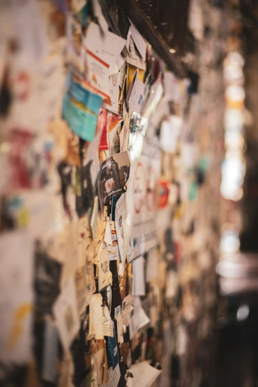 a wall covered with different colored pos and paper