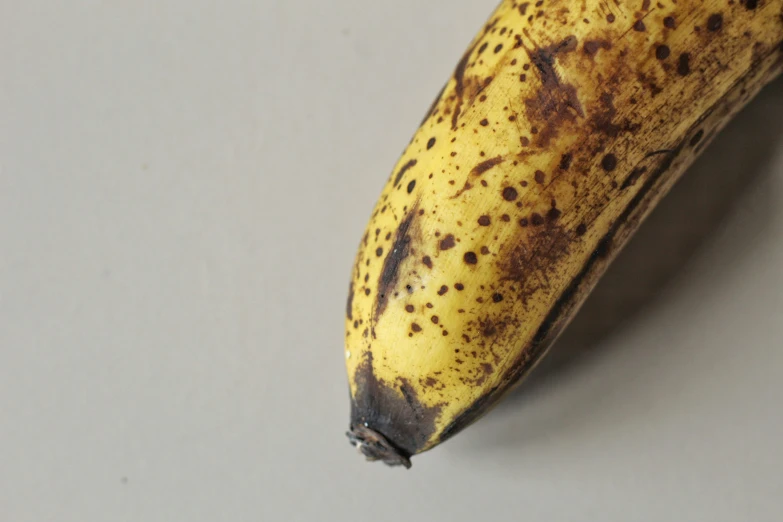 an overripe banana is sitting on a counter