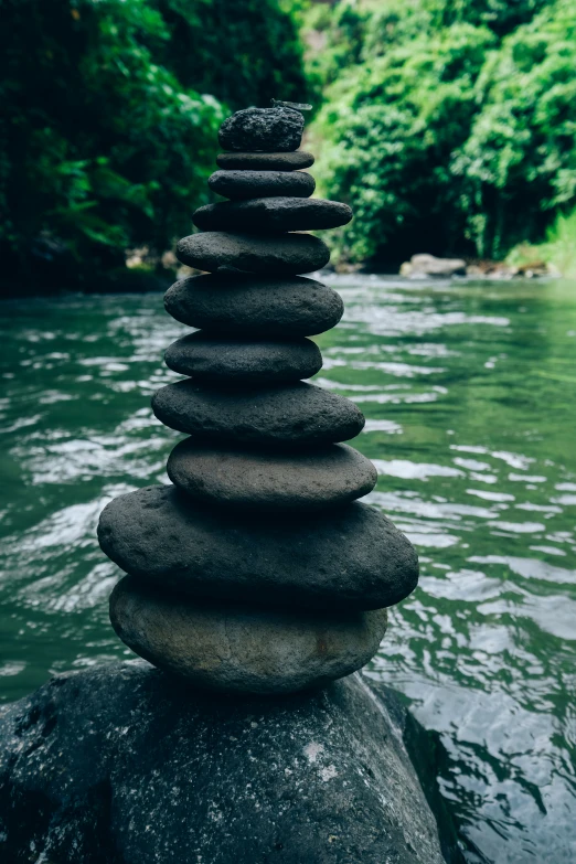 a tower of rocks is shown sitting on top of a rock