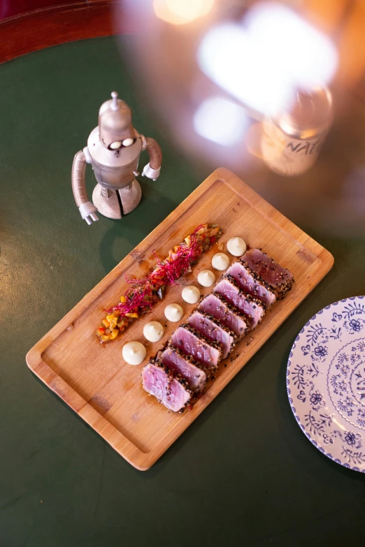 a wood  board with desserts and a coffee pot