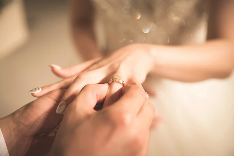 an engaged couple holding hands and touching each other