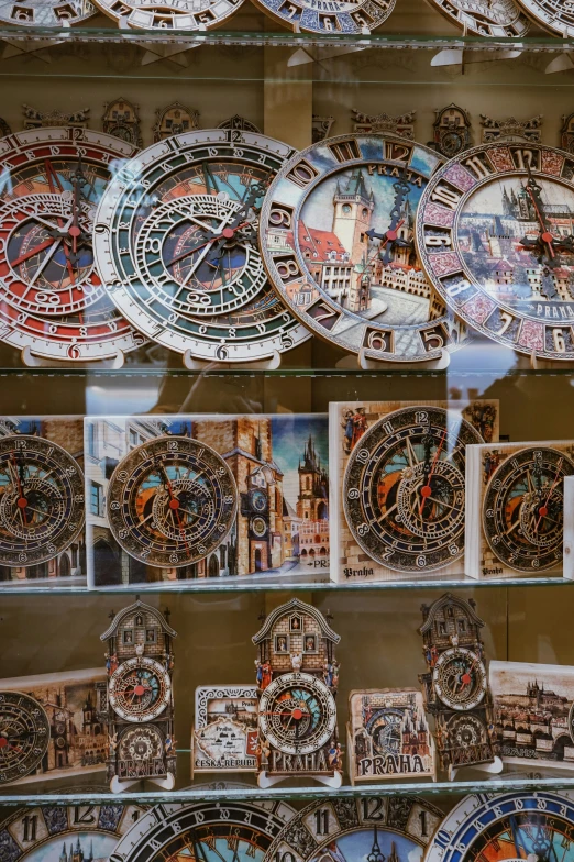 a large collection of decorative clocks displayed behind glass