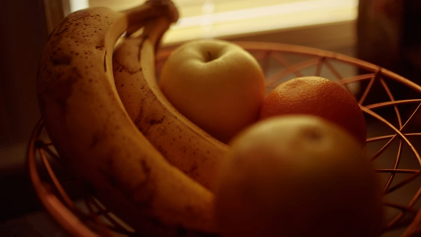 some ripe bananas and oranges in a bowl