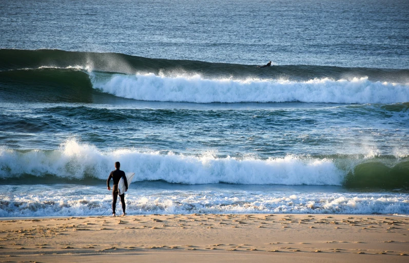 a surfer on the ocean waves in the distance