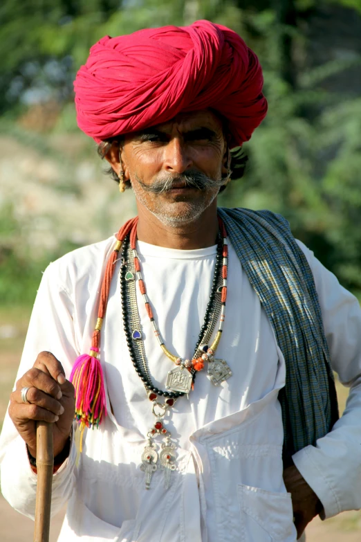 a man with a large headband and beads