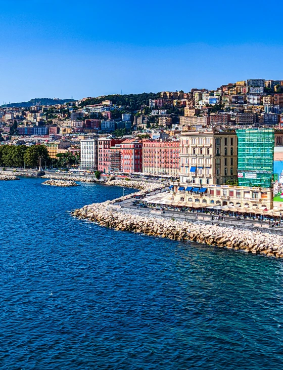 a city area next to the river with a large body of water in front of it