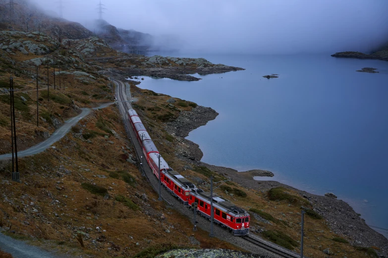 a red and white train is coming up some tracks