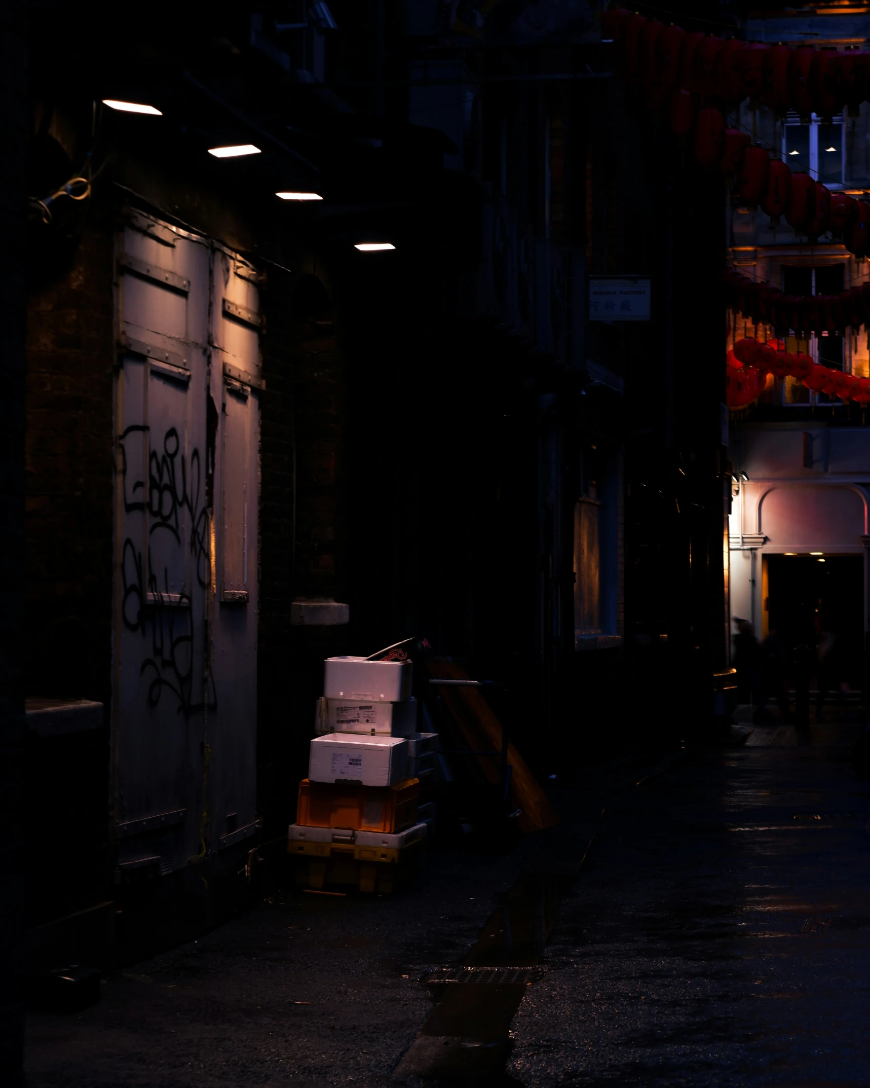 a few boxes on some pallets in the dark