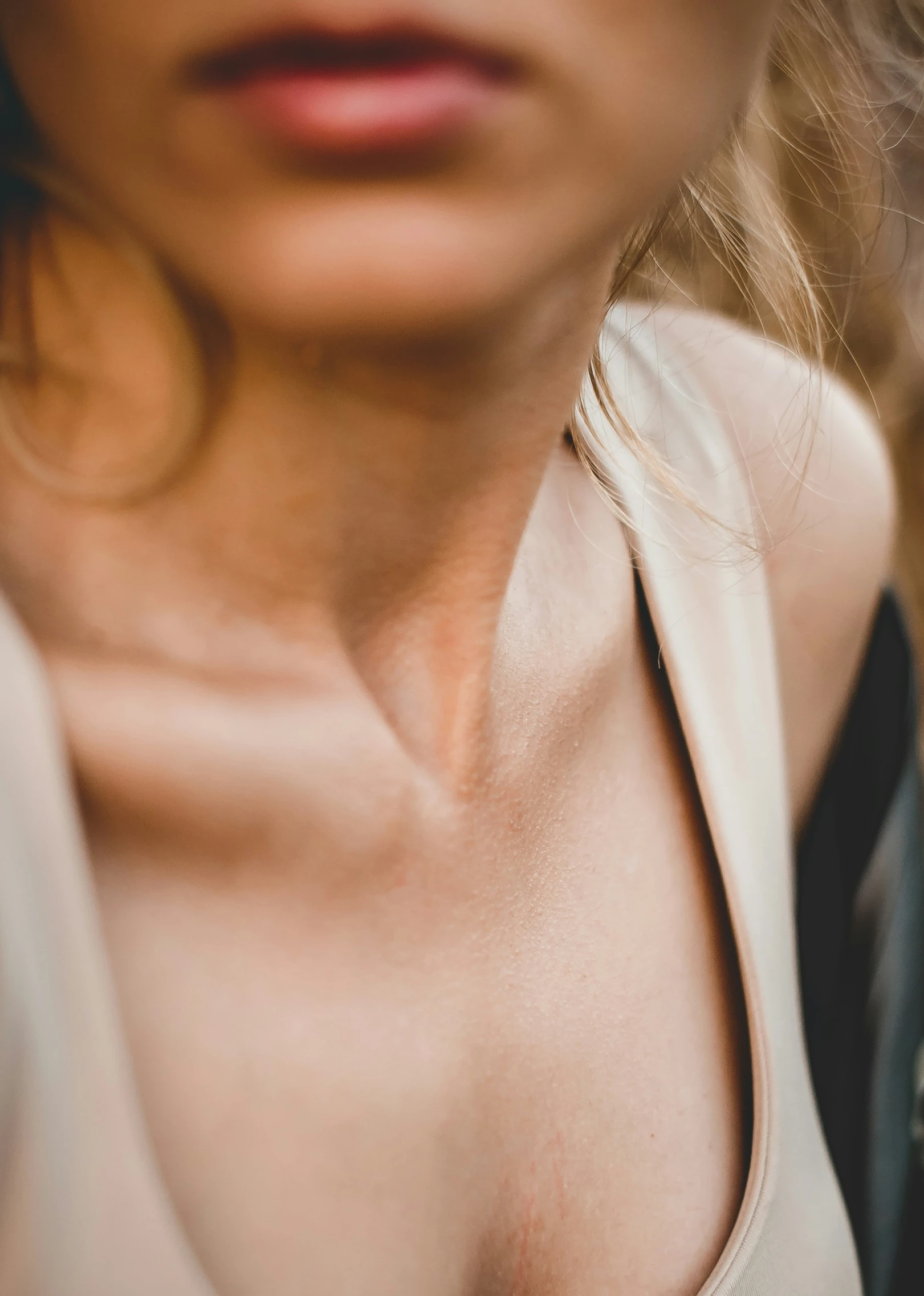 the chest of a woman in a light blouse