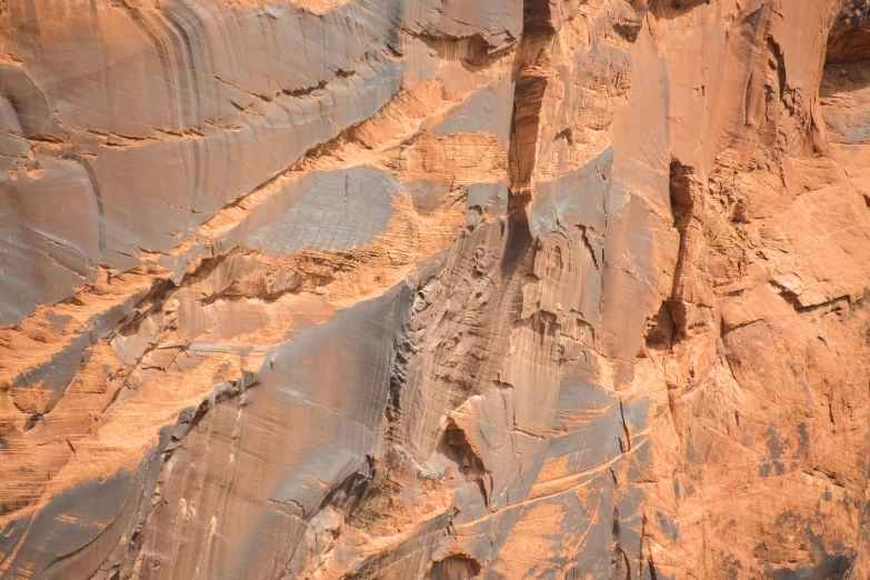 some very tall brown rocks and some trees